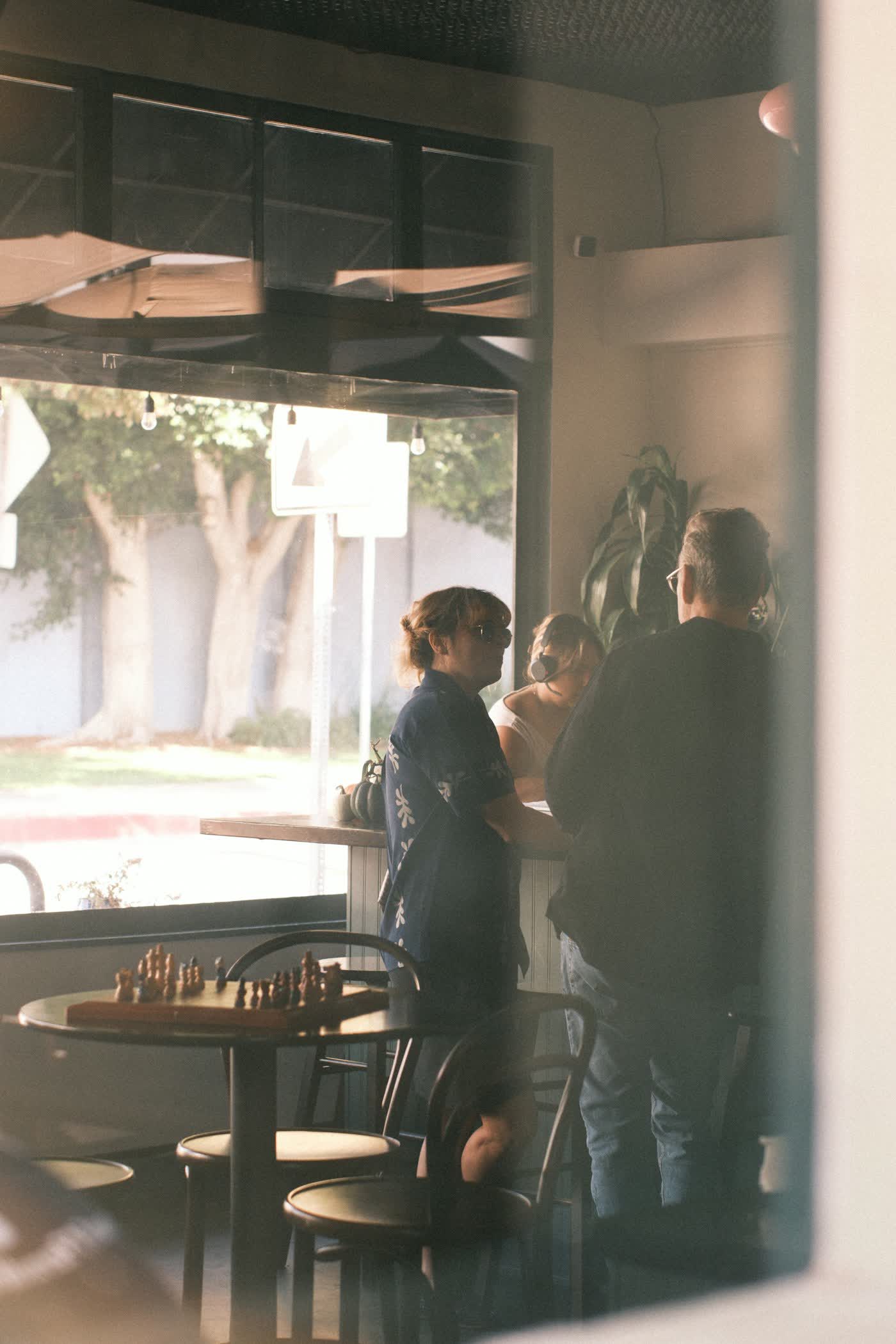 Two people having a conversation in a cafe